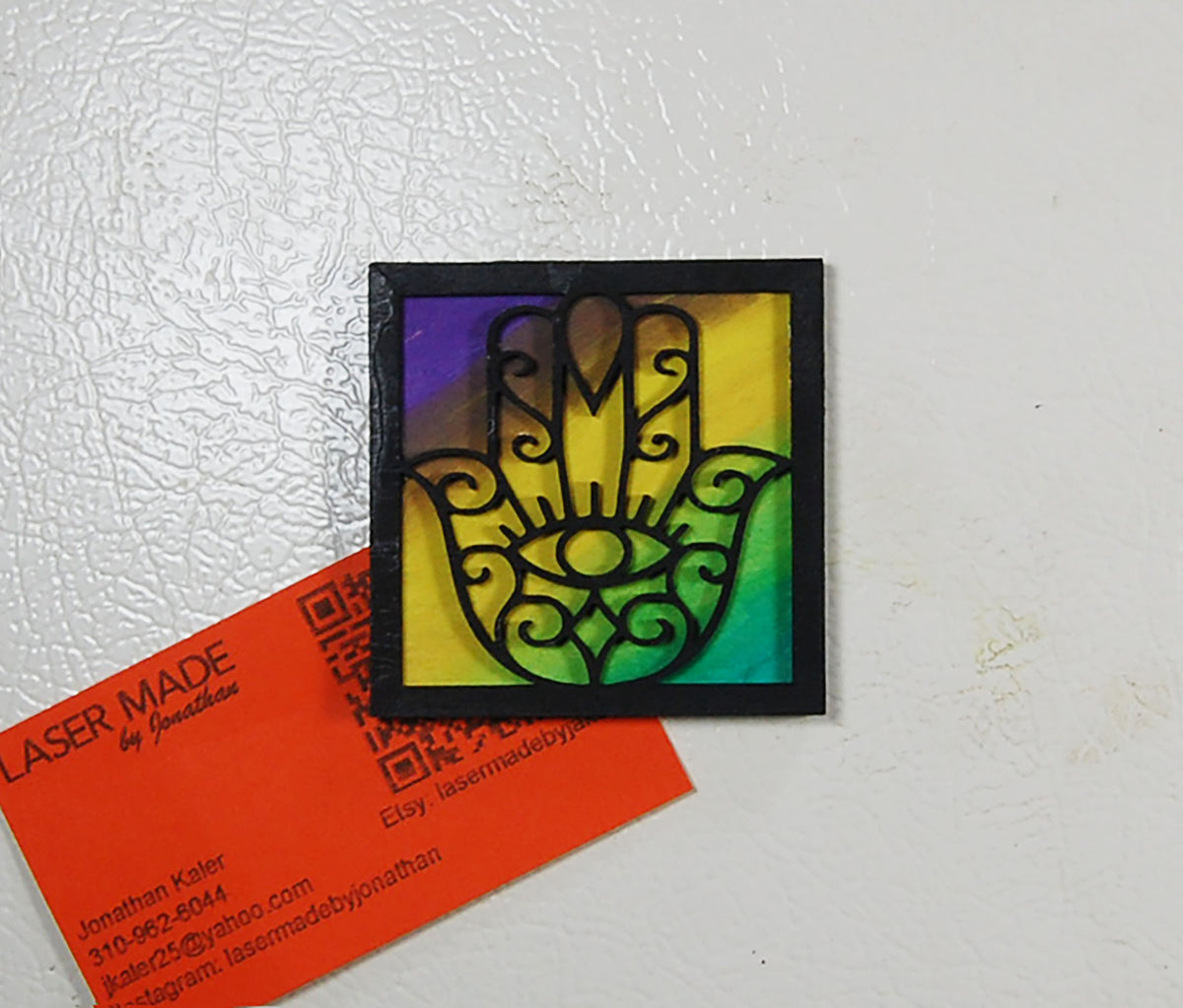 Hand-painted basswood Hamsa magnet in a colorful finish