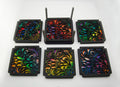 Six colorful laser-cut swirl coasters arranged in two rows