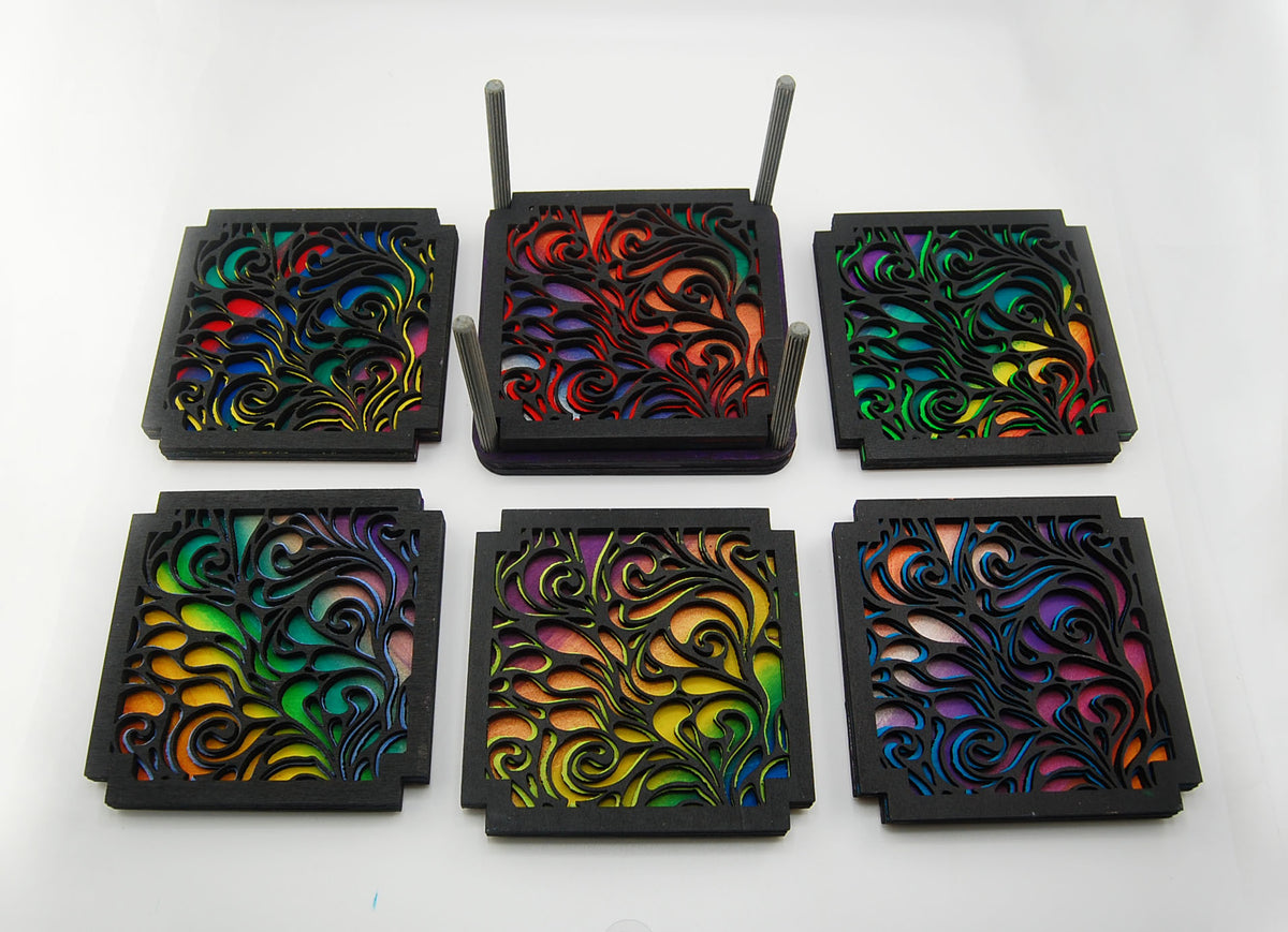 Six colorful laser-cut swirl coasters arranged in two rows