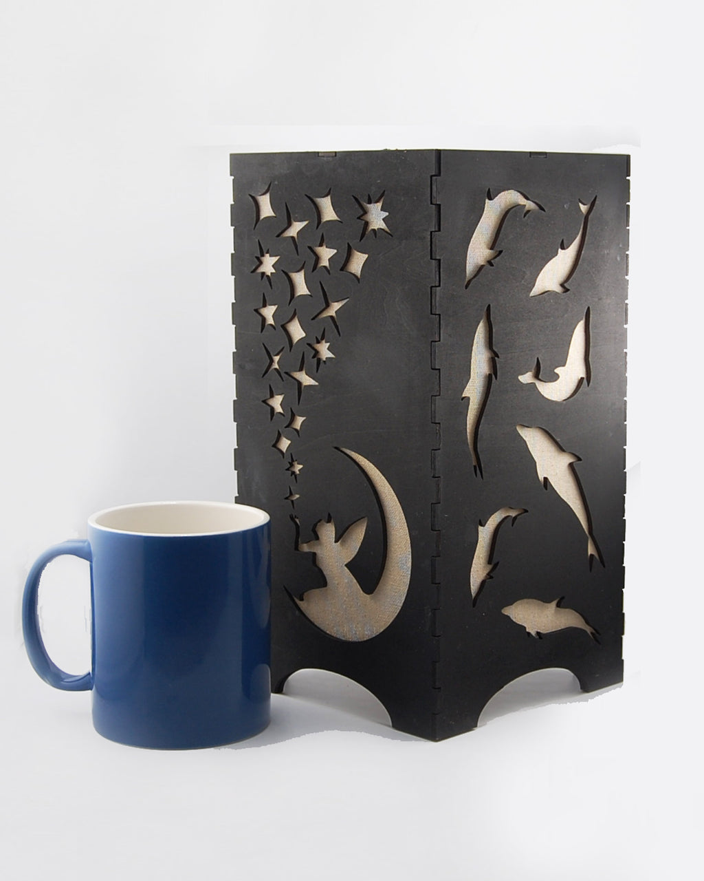 Fairies and dolphins lantern unlit beside a coffee mug for scale