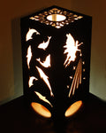 Fairies and dolphins lantern glowing with warm light, fairy and dolphin silhouettes illuminated