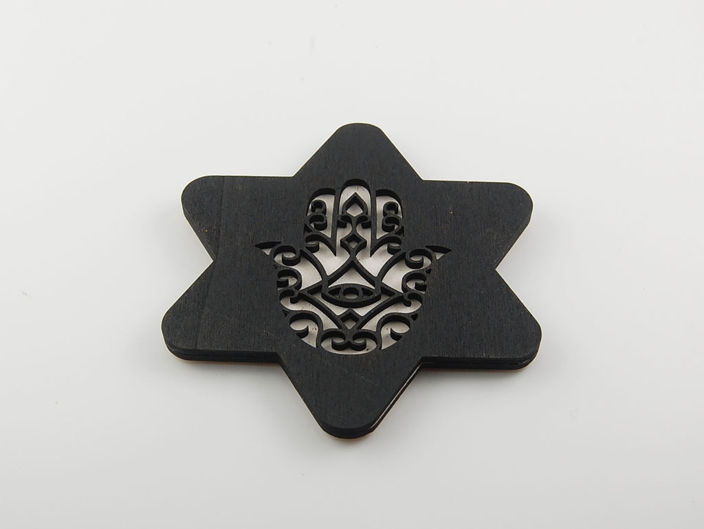 Star-shaped black coaster with a layered Hamsa and eye motif