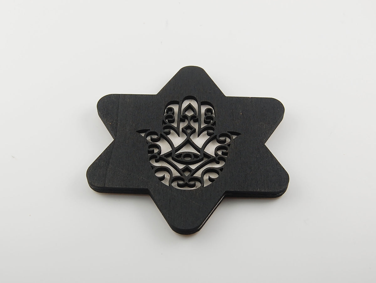 Star-shaped black coaster with a layered Hamsa and eye motif