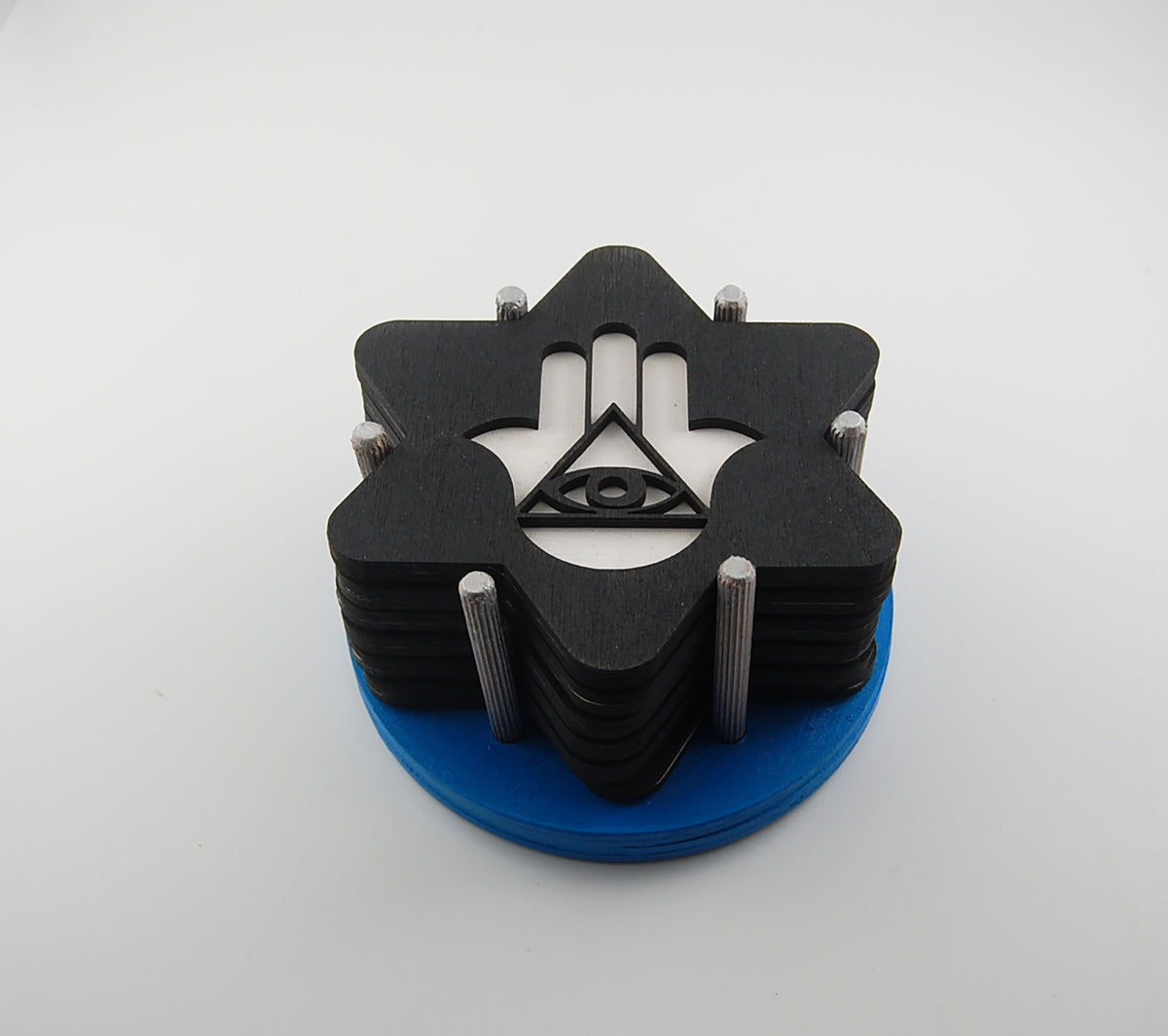 Hamsa and Star of David Judaica coaster set stacked in a blue storage holder