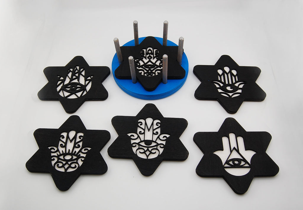 Six star-shaped Hamsa and Star of David Judaica coasters arranged together