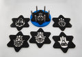 Six star-shaped Hamsa and Star of David Judaica coasters arranged together