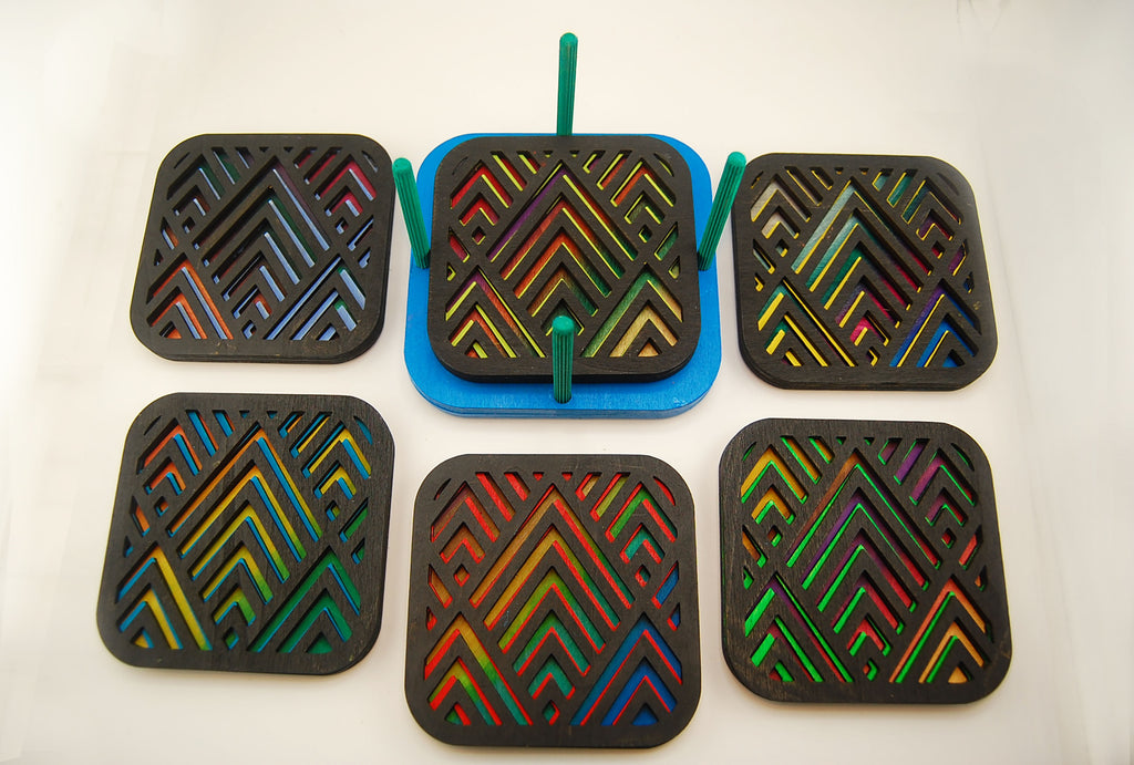 Six colorful square laser-cut angular coasters arranged together