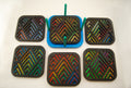 Six colorful square laser-cut angular coasters arranged together