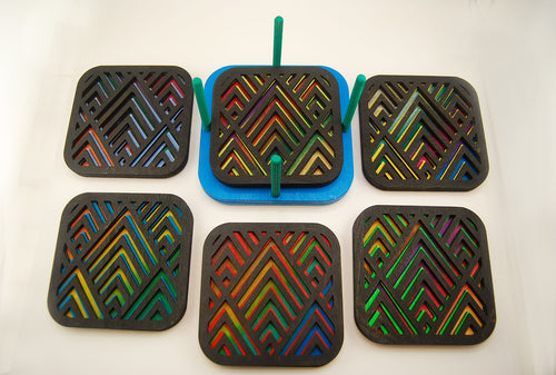 Six colorful square laser-cut angular coasters arranged together