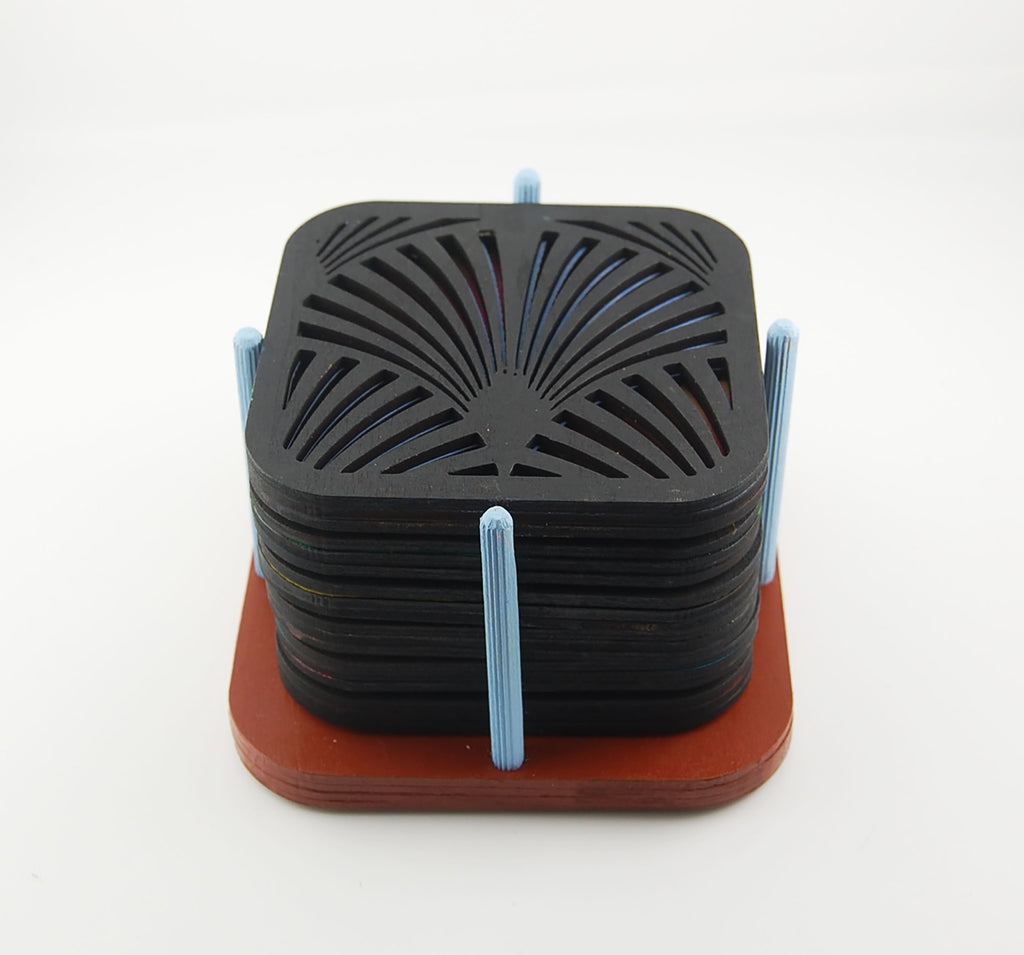 Six square laser-cut Deco coasters arranged in a red storage holder