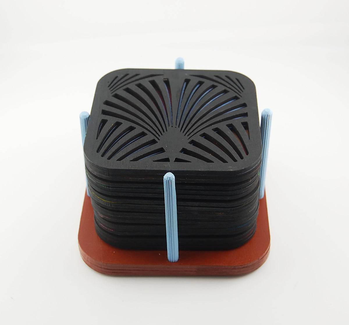 Six square laser-cut Deco coasters arranged in a red storage holder