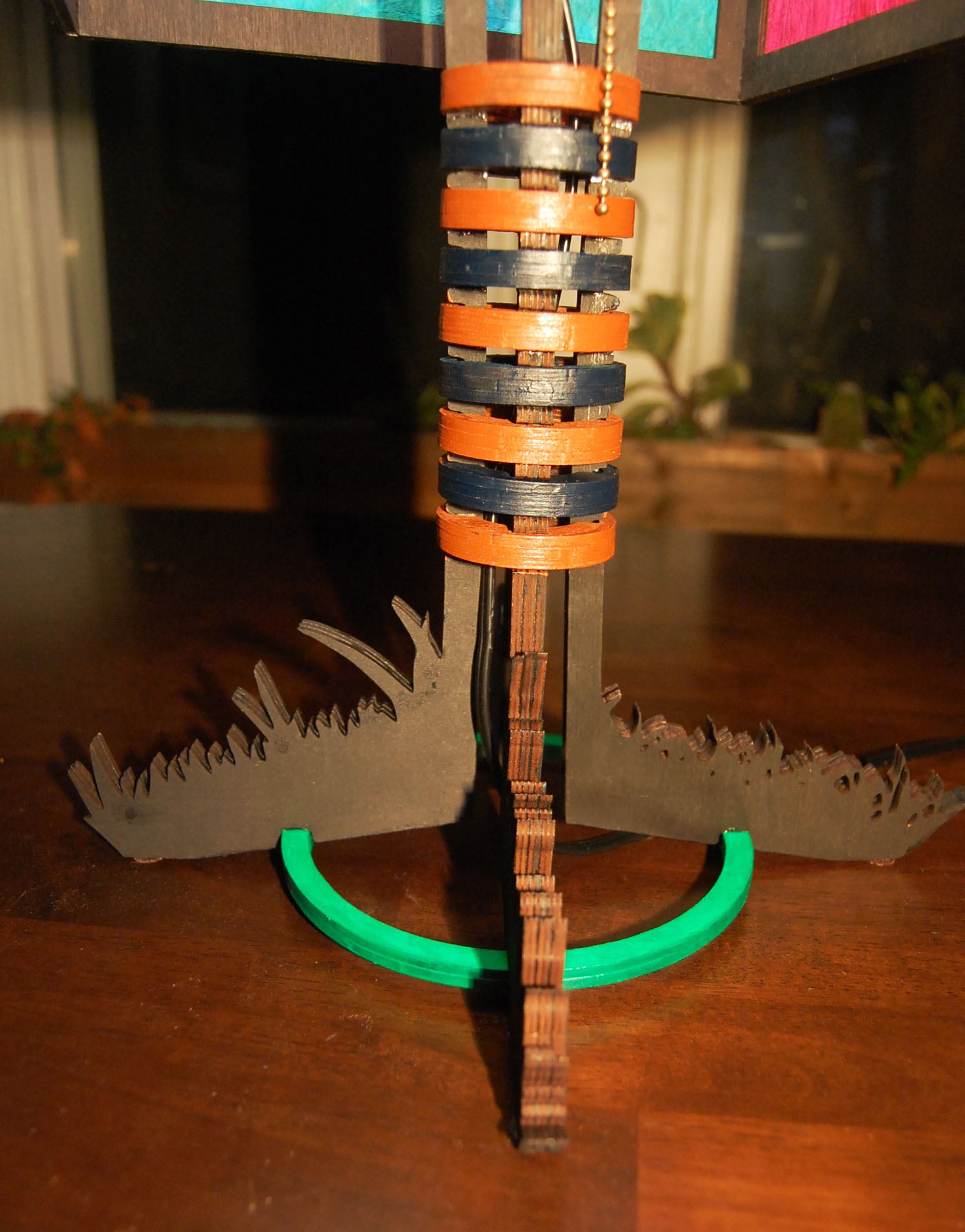 Base and stem detail showing stacked orange and navy painted rings with pull cord