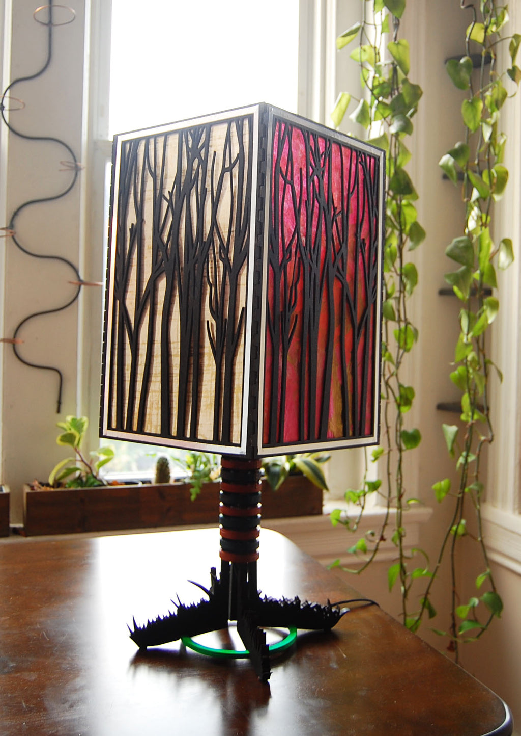 Forest Light lamp unlit in natural daylight showing basswood construction and colored paper panels