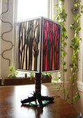 Forest Light lamp unlit in natural daylight showing basswood construction and colored paper panels