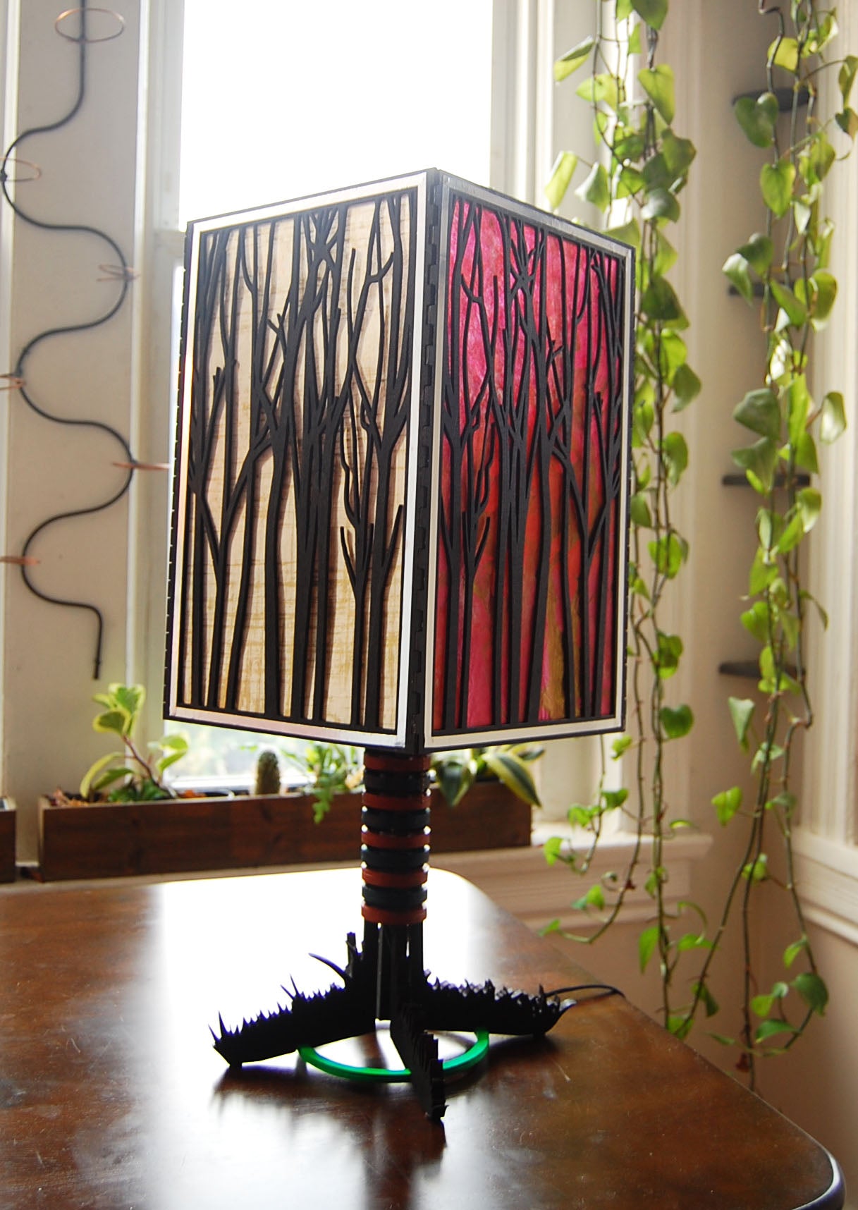 Forest Light lamp unlit in natural daylight showing basswood construction and colored paper panels