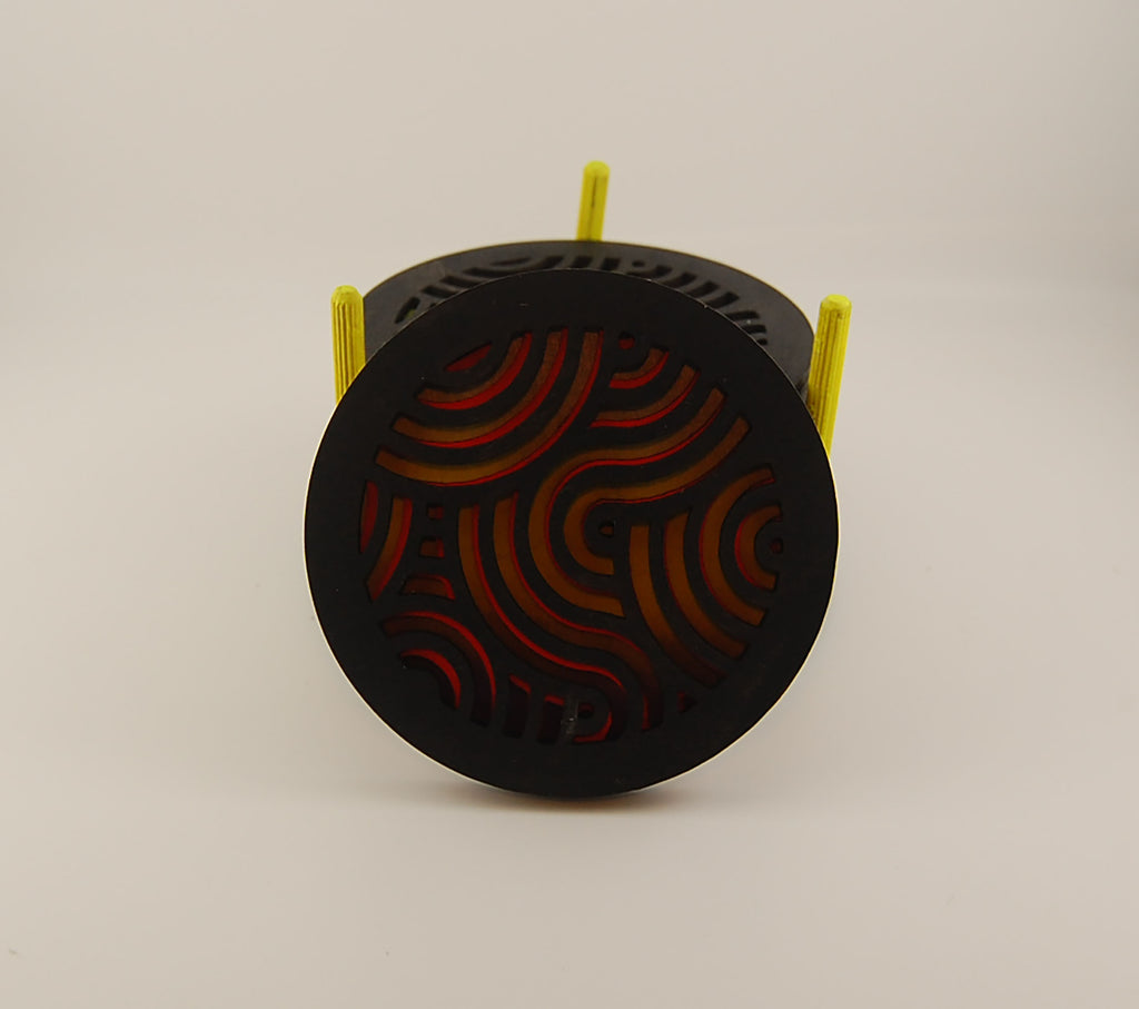 Close-up of a round laser-cut coaster with wavy geometric pattern
