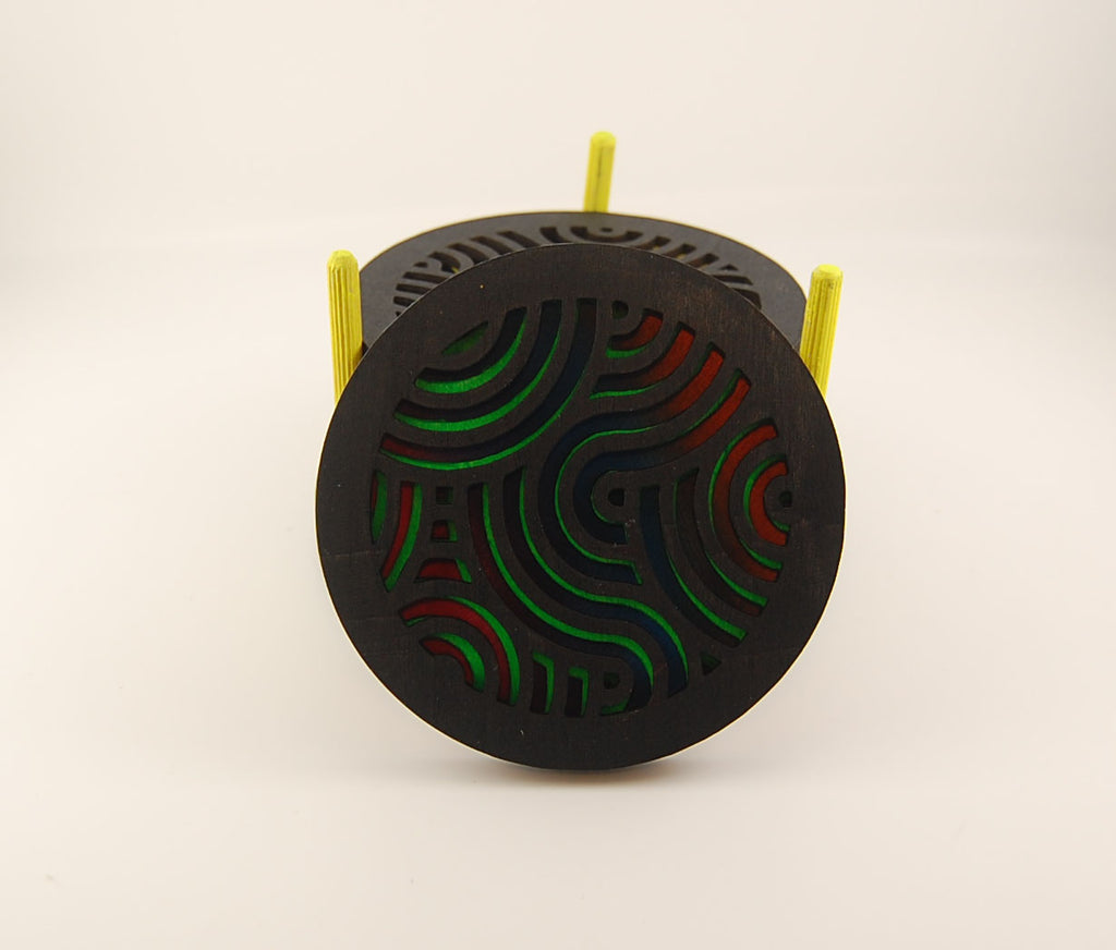 Stack of round laser-cut coasters in a colorful storage holder