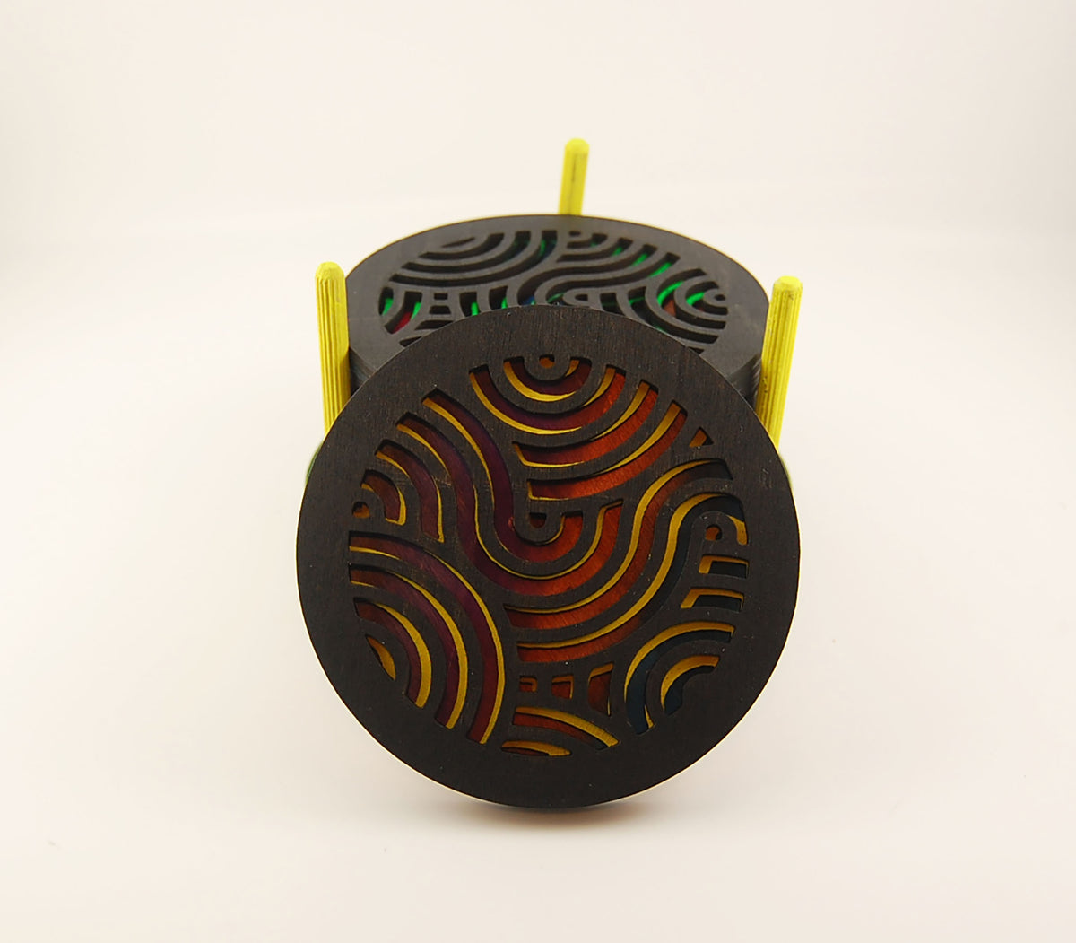 Round coaster with multicolor abstract design and wavy laser-cut surface
